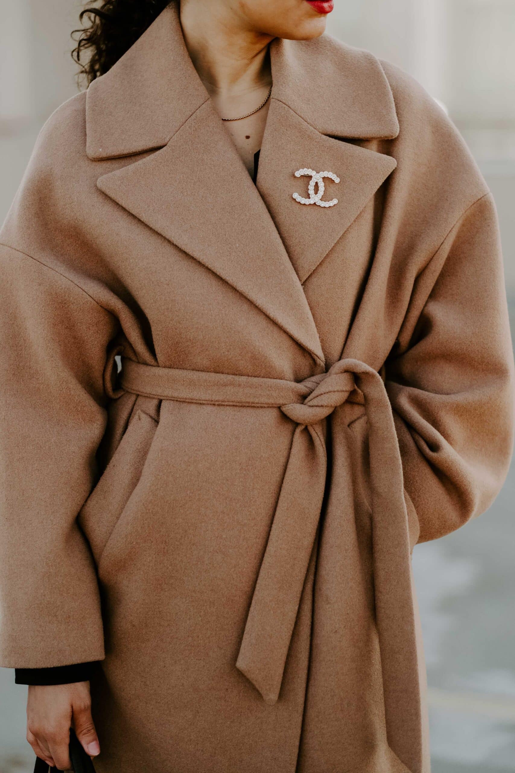 camel coat brooch outfit