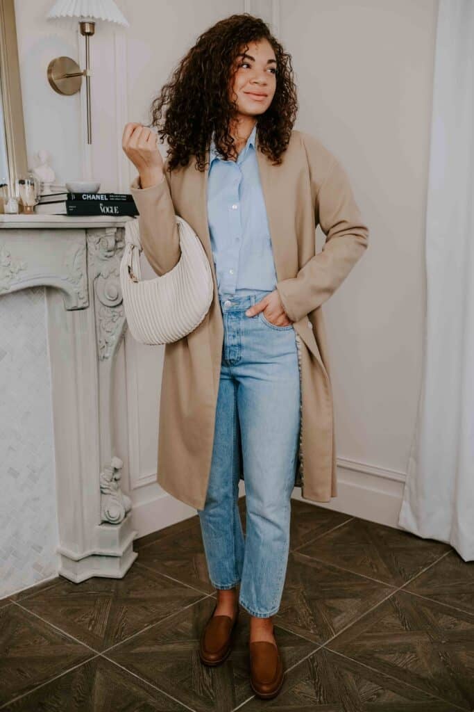 cute outfits with jeans: blue button-up, jeans, loafers, coat, handbag