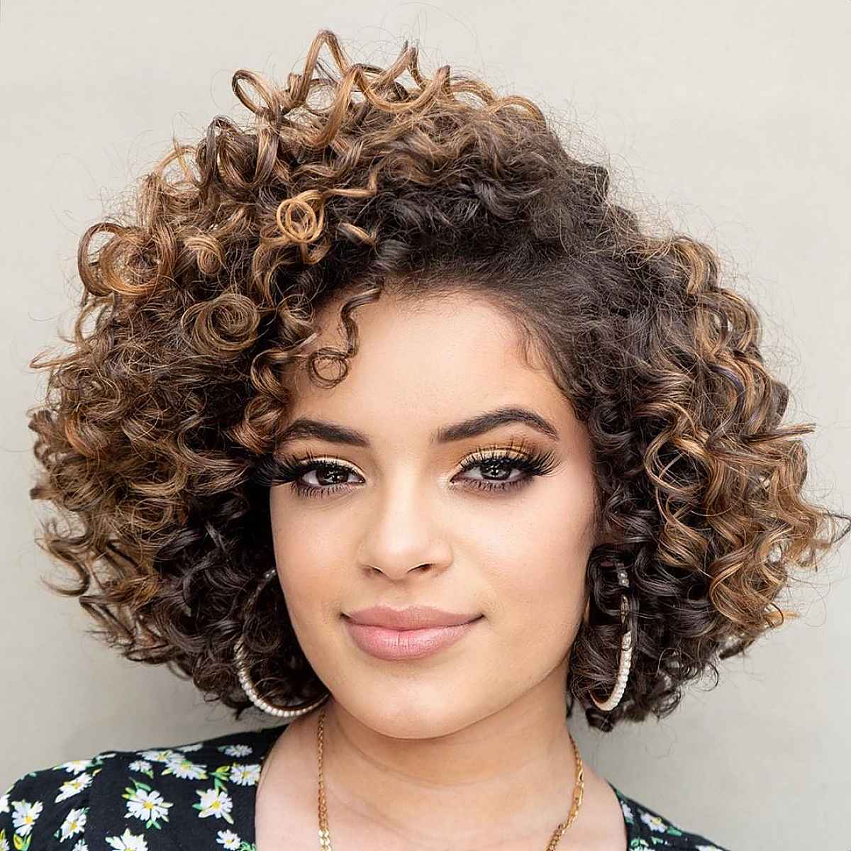 Short curly brunette hair with lob