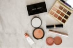 Makeup flat lay of Tarte cosmetics eyeshadow and Bobbi Brown palette