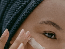 black woman applying eye cream